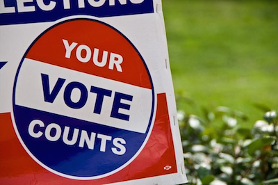votre vote compte sur un panneau de pelouse
